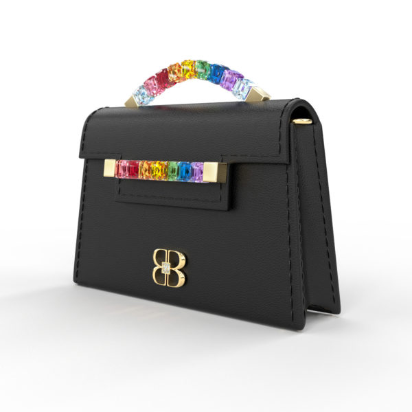 Front side angle view of black Rainbow Baby Jewel Crossbody showing a slender, collapsible side profile. Emerald-cut Swarovski crystals are flush together at their edges, forming a rainbow gradient with square-shaped yellow gold hardware end caps.