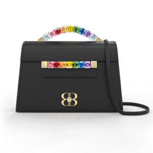 Front view of black Rainbow Baby Jewel Crossbody bag with a tapered trapezoidal shape, multi-colored Swarovski crystal top handle and front strap, yellow gold hardware, yellow gold and crystal BB plaque, and black detachable shoulder strap.