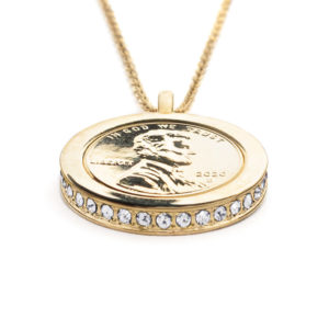 Side view of the Hope, Wear to Evoke Protection pendant and necklace with plated US penny set into a 22 carat band edged with clear Swarovski crystals.