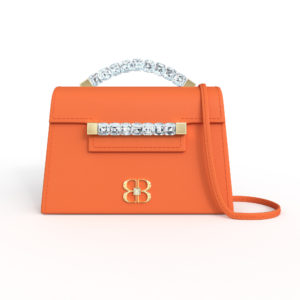 Front view of tangerine orange Baby Jewel Crossbody bag with a tapered trapezoidal shape, clear Swarovski crystal top handle and front strap, yellow gold hardware, yellow gold and crystal BB plaque, and matching orange detachable shoulder strap.